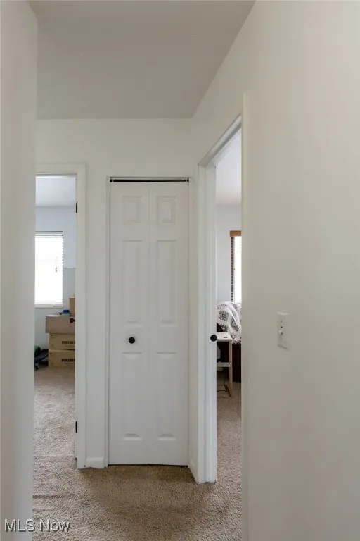 Hall with light colored carpet