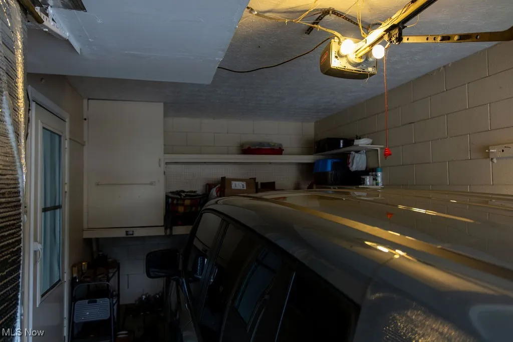 Garage with concrete block wall and a garage door opener