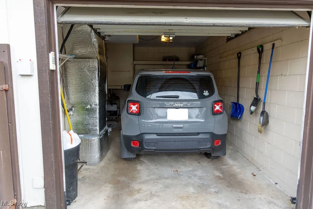 Garage featuring heating unit and a garage door opener