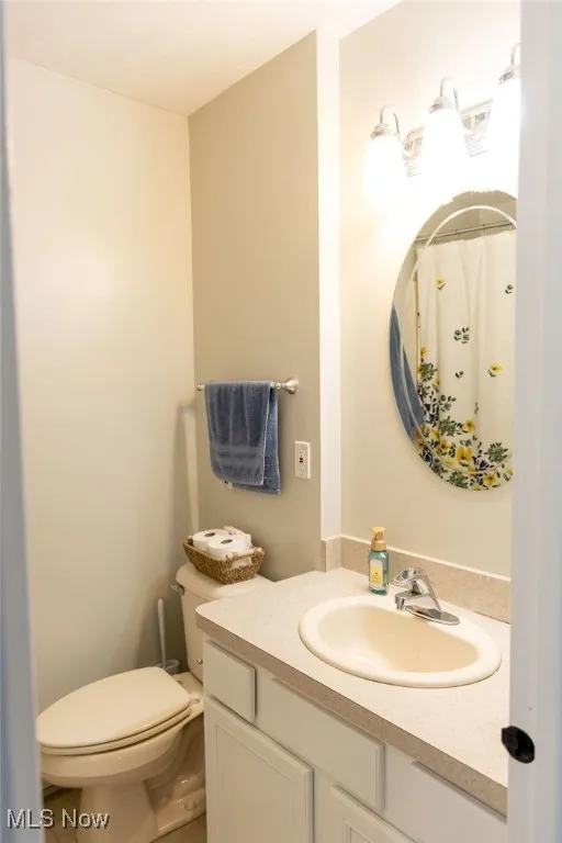 Full bathroom with vanity and curtained shower
