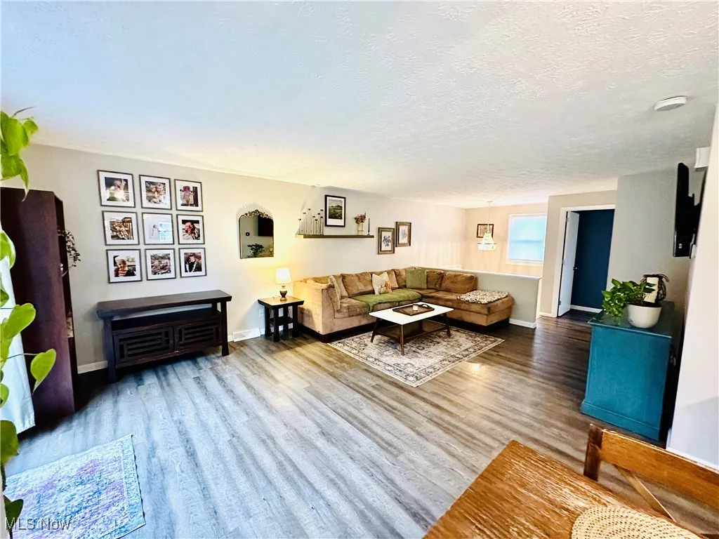 Living area with a textured ceiling and wood finished floors