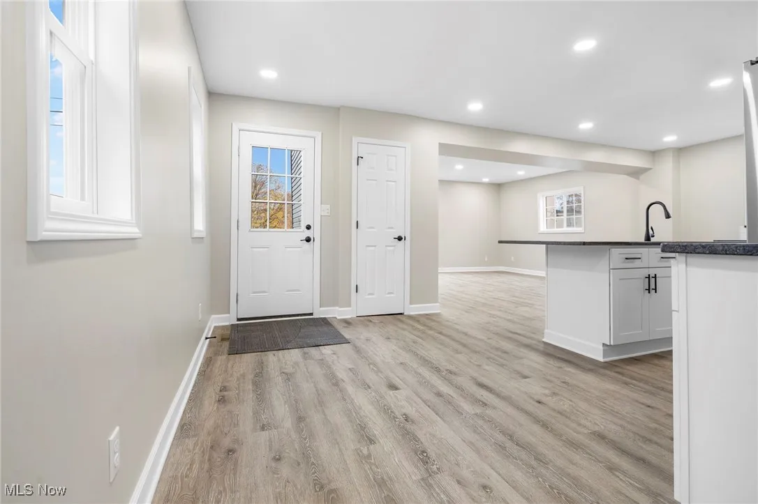 Entryway with light wood-type flooring and recessed lighting