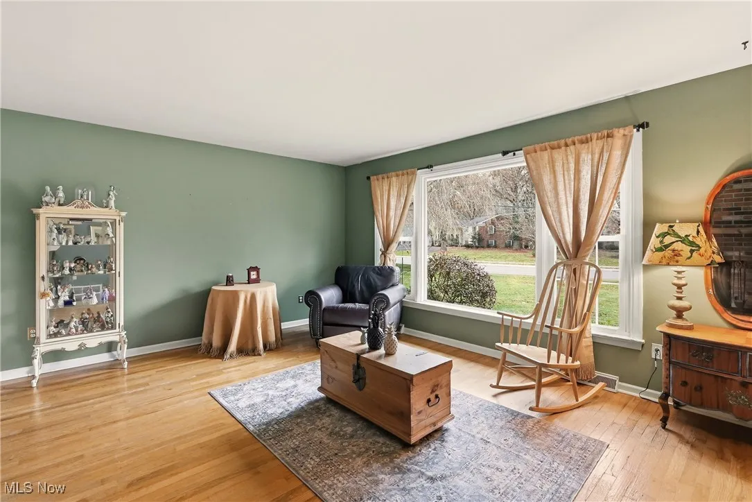 Sitting room with light wood-style floors and baseboards