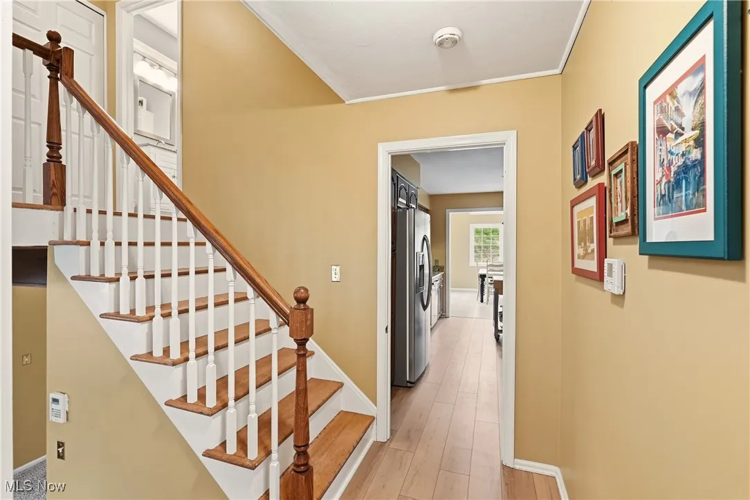 Staircase featuring baseboards and wood finished floors