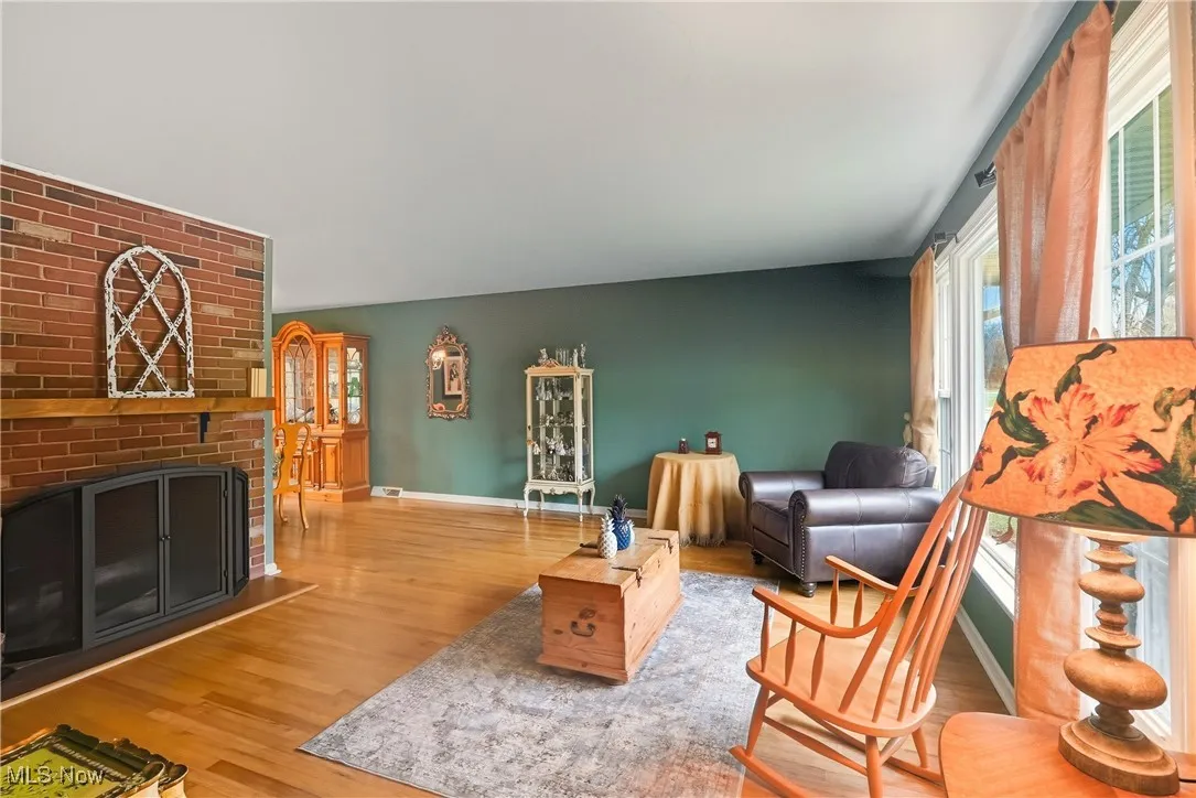 Living room with a fireplace and wood finished floors