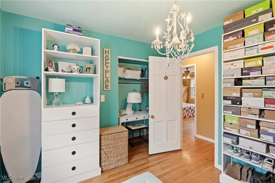 Bedroom featuring a chandelier and light wood-type flooring