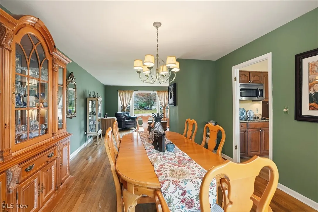Dining area with a chandelier and hardwood / wood-style flooring