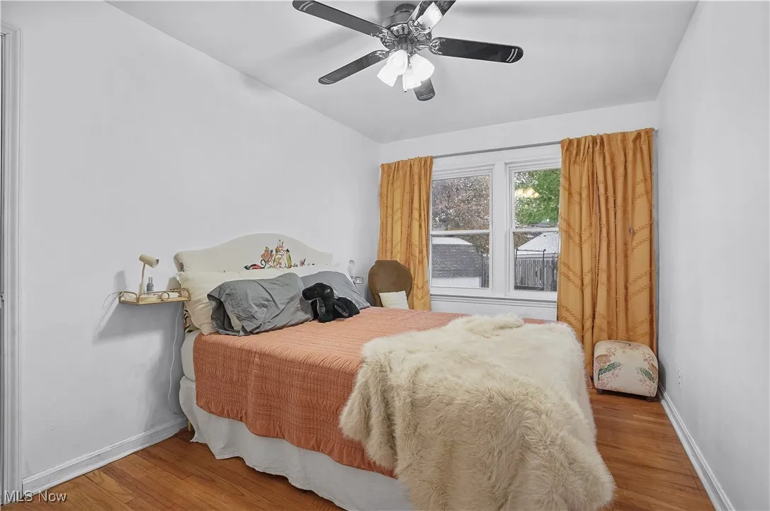 Bedroom with light wood-style flooring and a ceiling fan