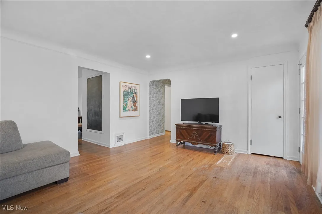 Living room featuring light wood-style flooring and recessed lighting