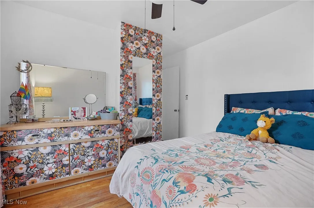 Bedroom featuring wood finished floors and a ceiling fan