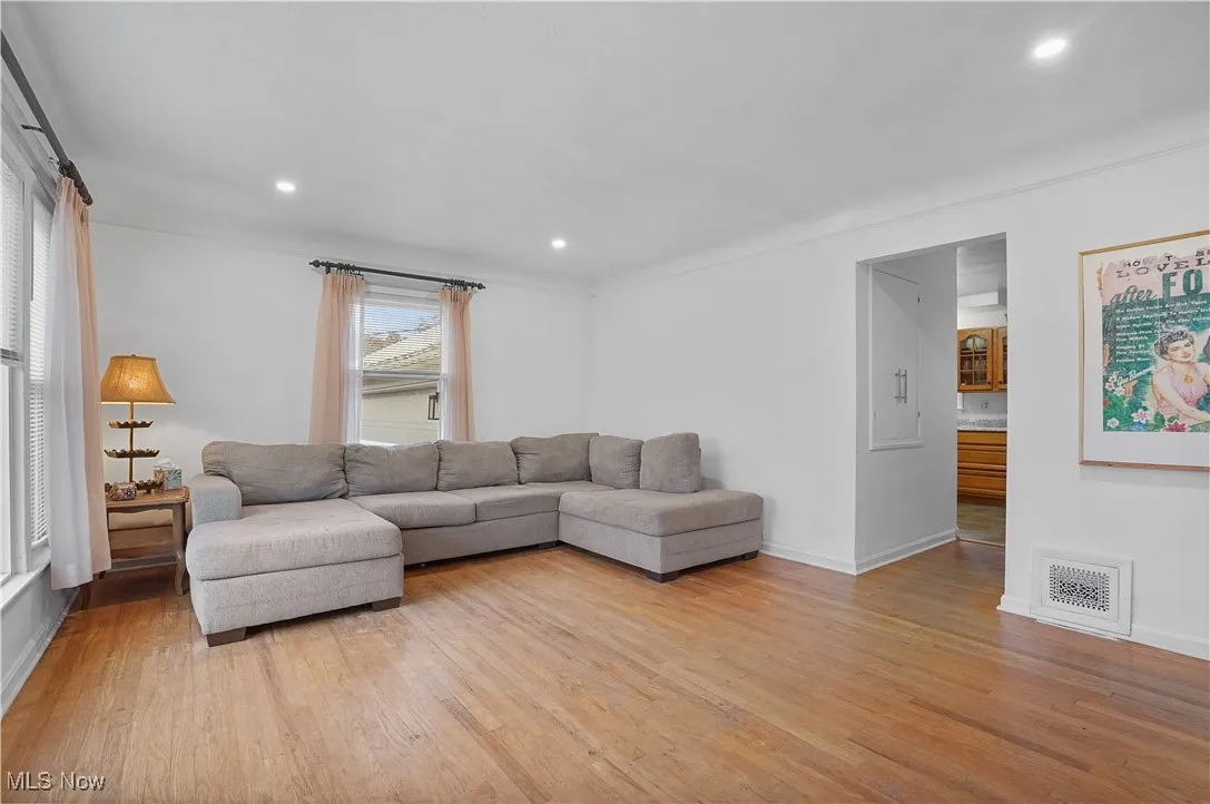 Living area featuring light wood-style floors and recessed lighting