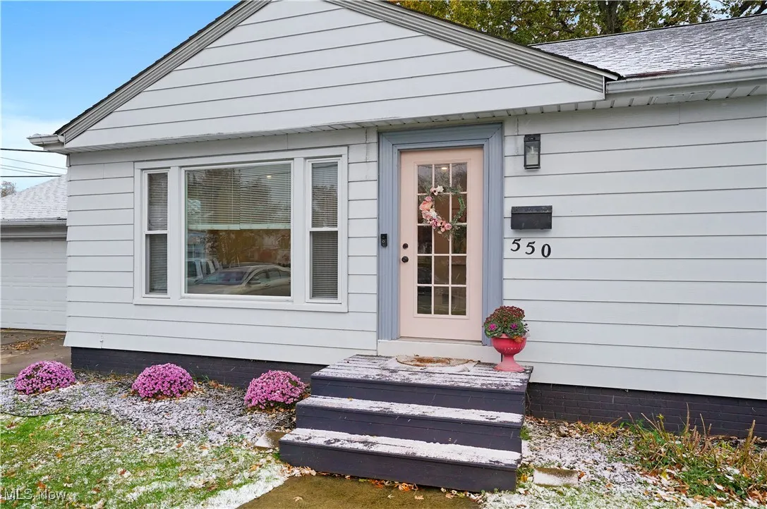 View of exterior entry with a garage