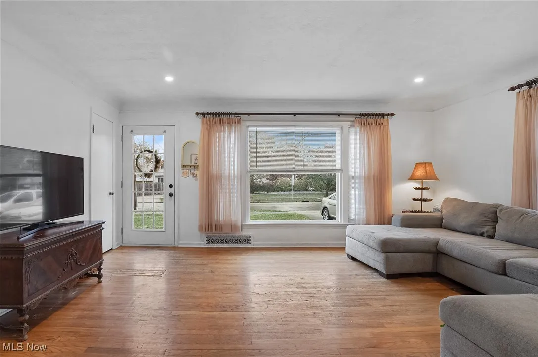 Living area with light wood-type flooring, plenty of natural light, and recessed lighting