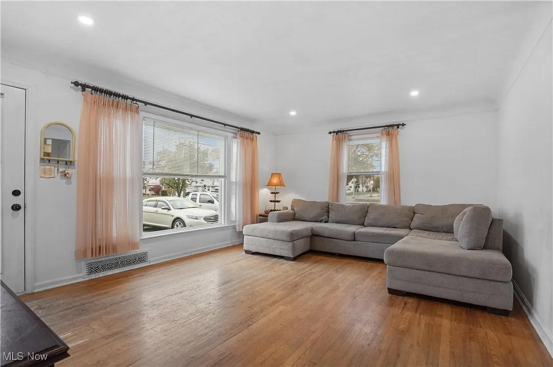 Living area featuring light wood-style floors and recessed lighting