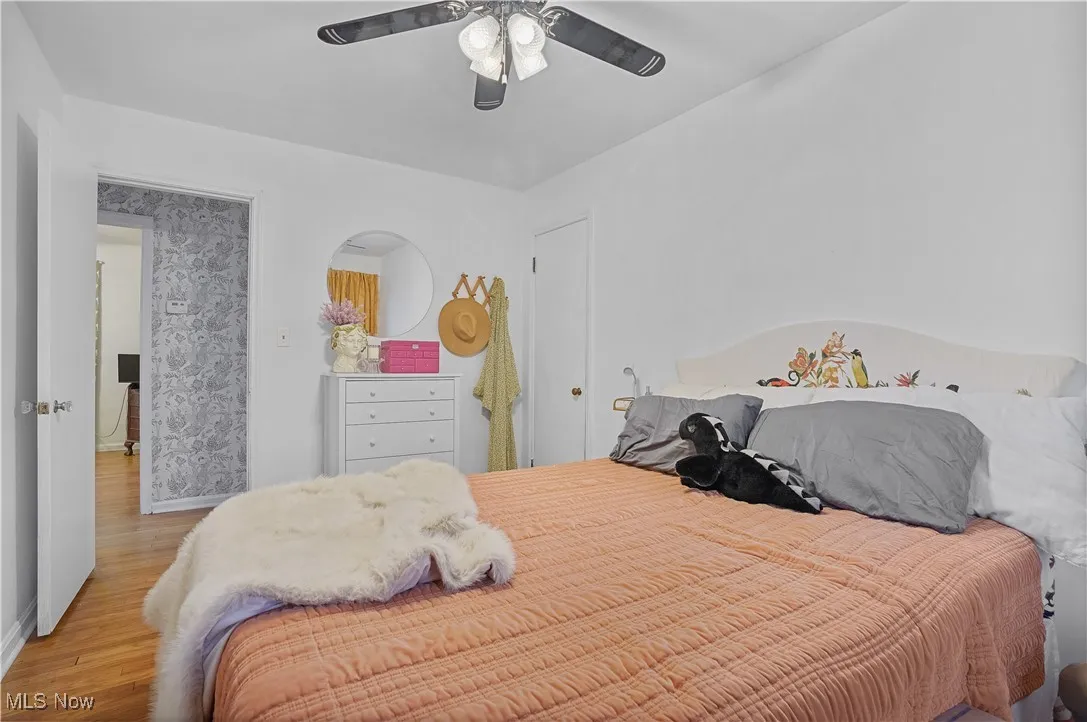 Bedroom with wood finished floors and a ceiling fan