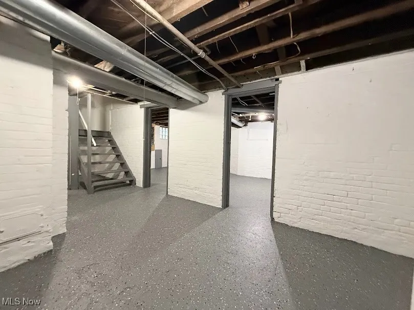 Unfinished below grade area featuring stairs