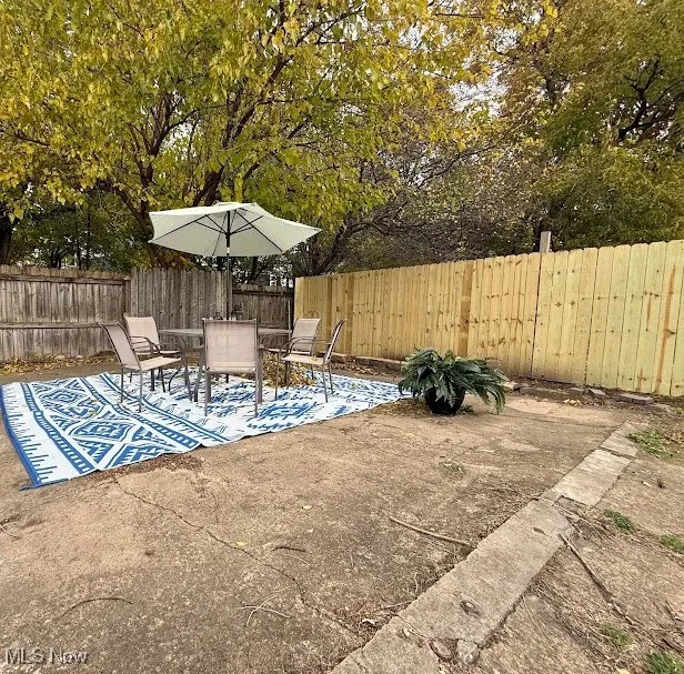 Fenced backyard with a patio