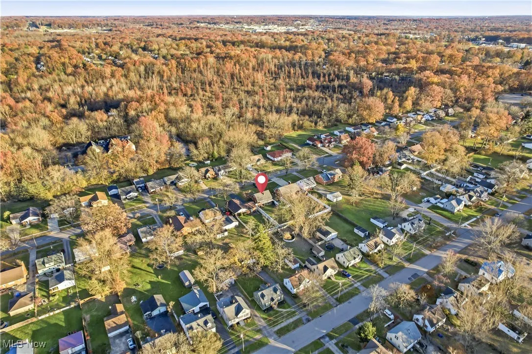 Aerial view of property's location with nearby suburban area