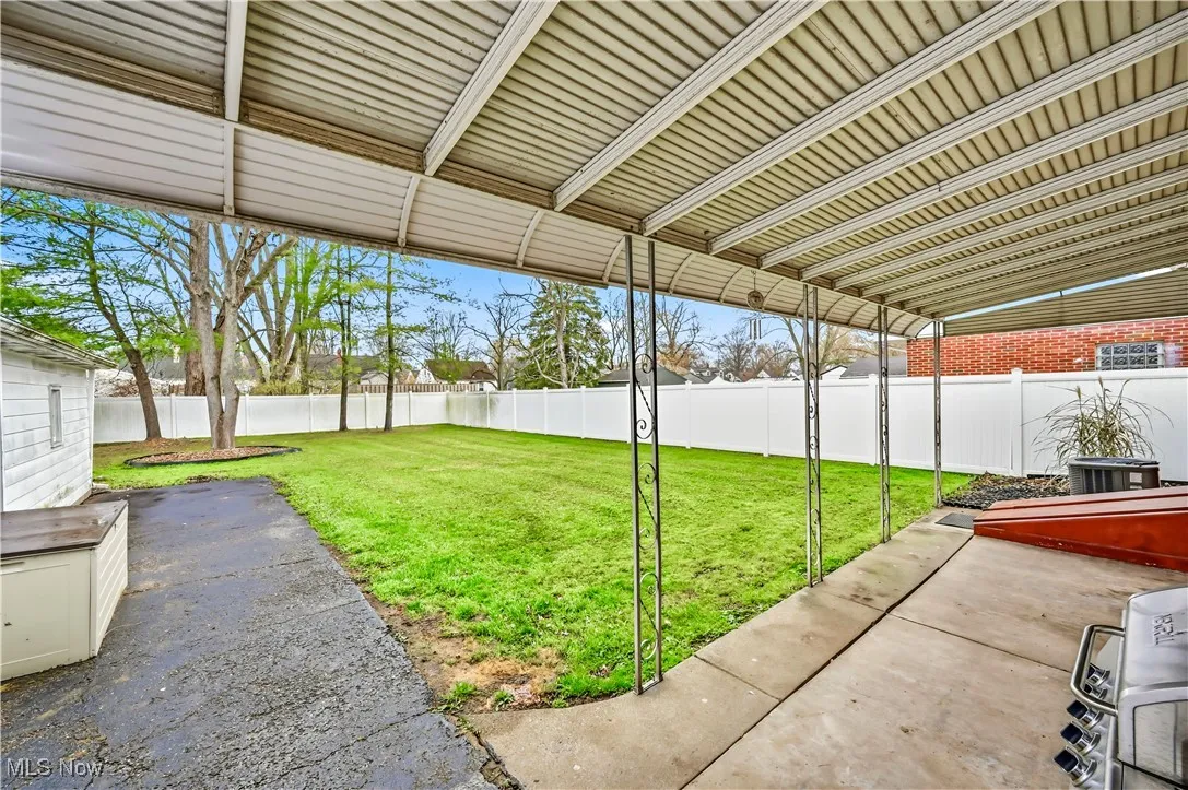 Fenced backyard with a patio area