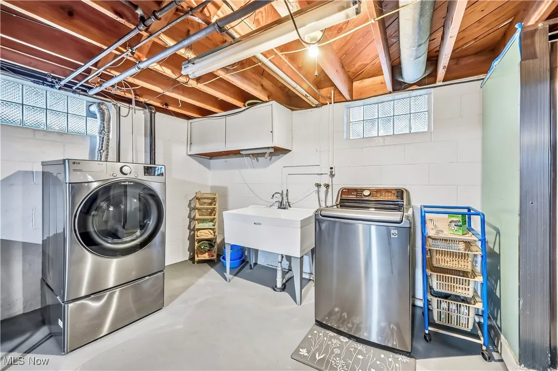 Laundry room with concrete floors, plenty of natural light, and washer and dryer