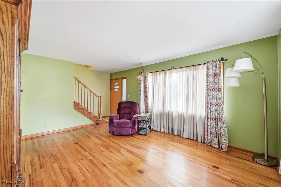 Living area with stairway and light wood finished floors