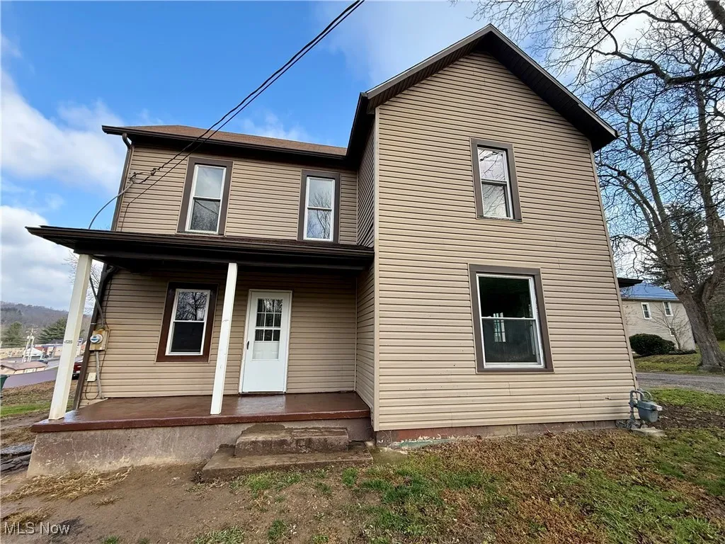 Rear view of property with a porch
