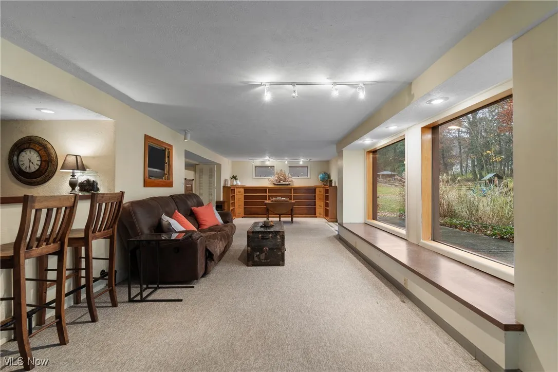 Living room with light carpet and recessed lighting