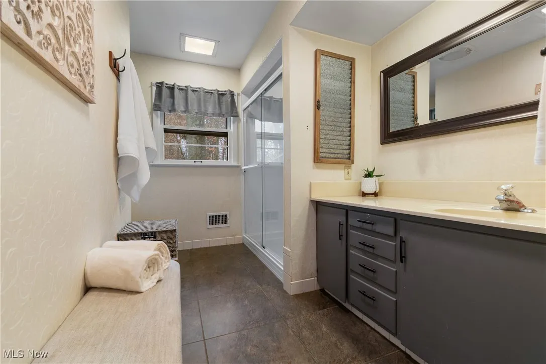 Full bath featuring vanity and a stall shower