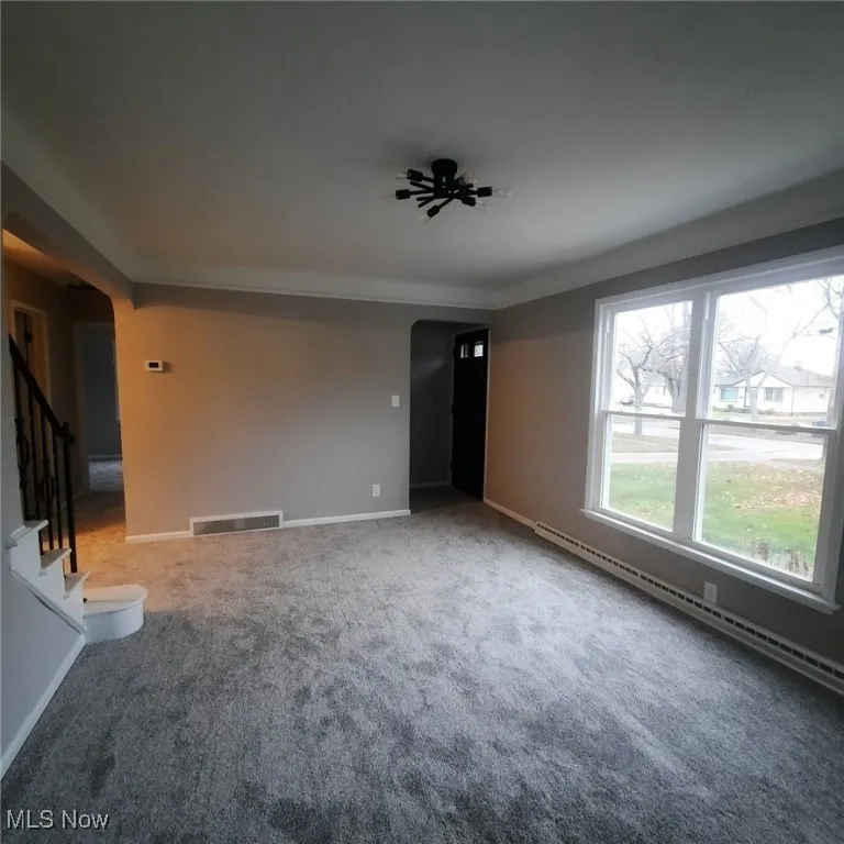 Living Room with foyer entry, boasts new windows to enjoy loads of natural light, new carpeting & paint.
