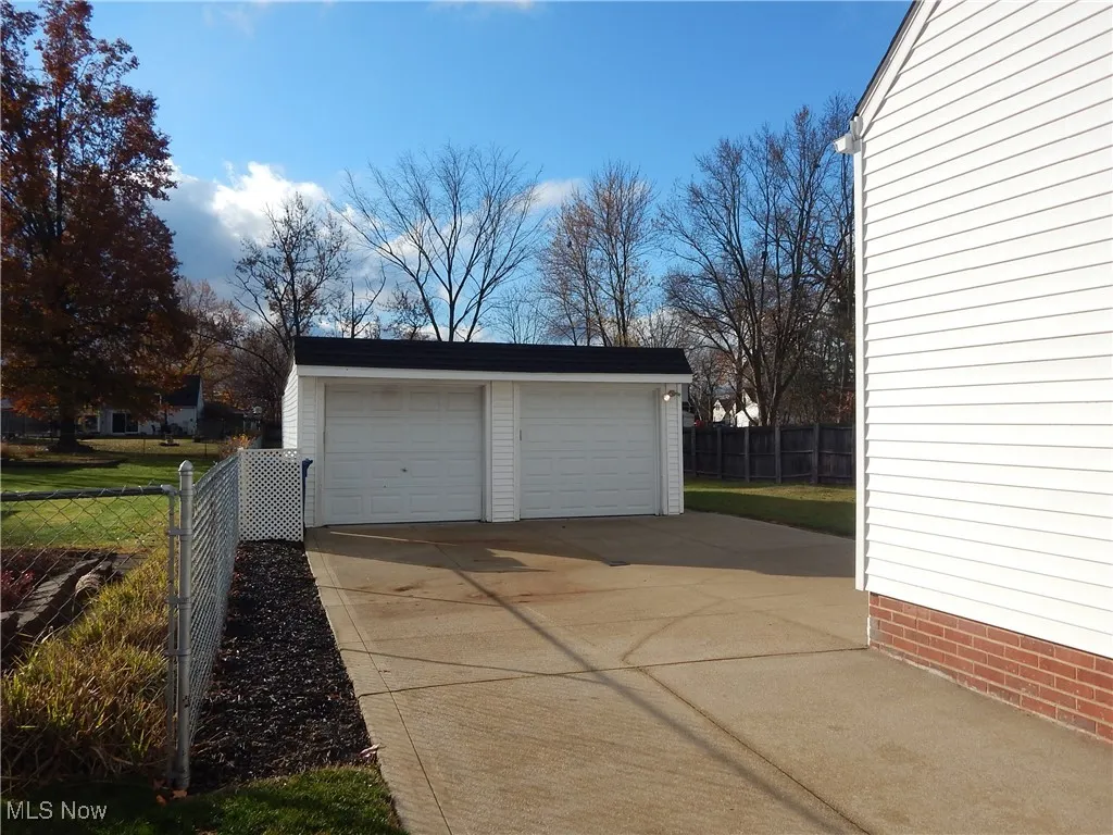 Oversized garage has an updated concrete floor & Doors. Addition of Workshop on rear and updated  concrete driveway.