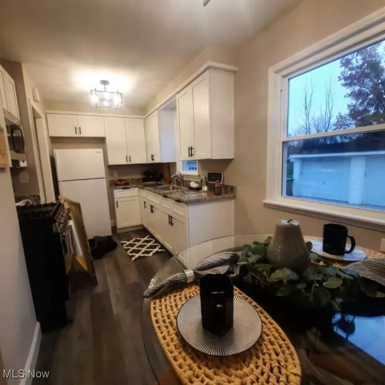 Long view of Kitchen features New windows that enhance the dDning area of this kitchen.