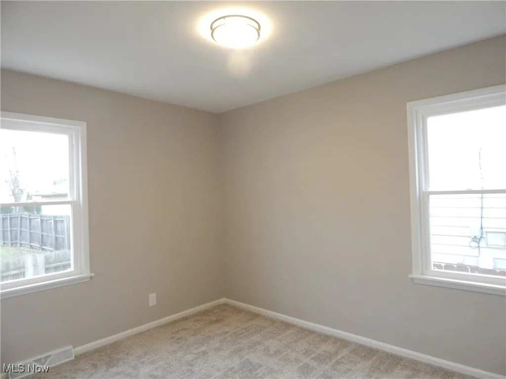 Bedroom 2 enjoys new windows, carpeting, fresh paint & light fixture.