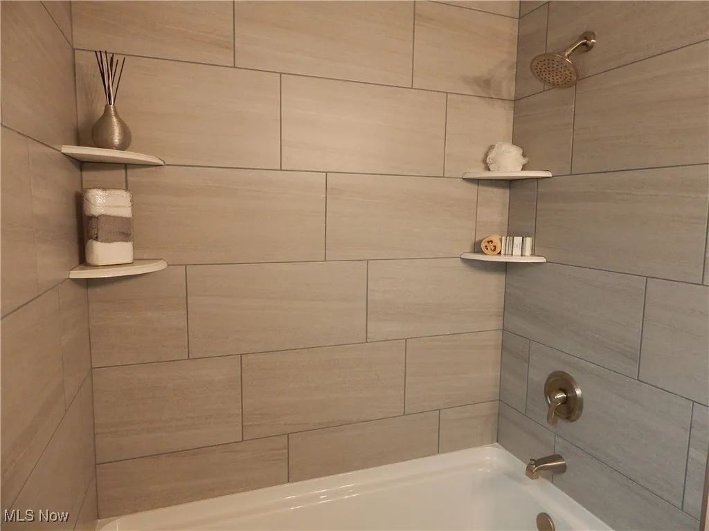 All new Full bath featuring shower / tub combination with custom tile work and new plumbing fixtures.