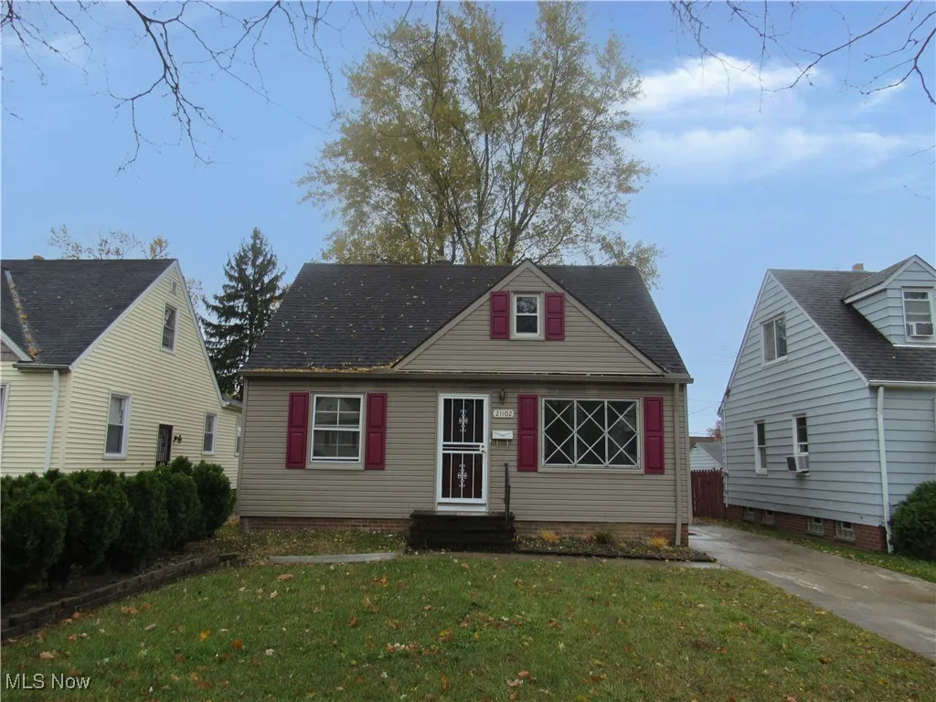 Cape cod-style house featuring a front lawn, entry steps, and roof with shingles