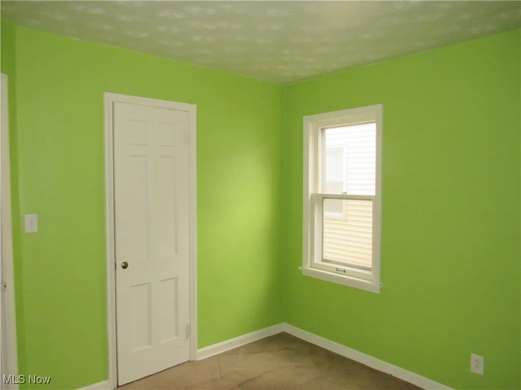 Unfurnished bedroom featuring baseboards and a closet