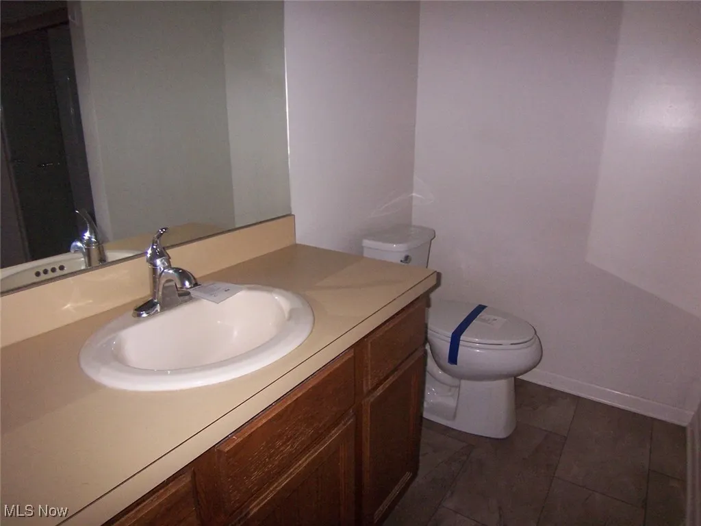 Bathroom featuring vanity and toilet