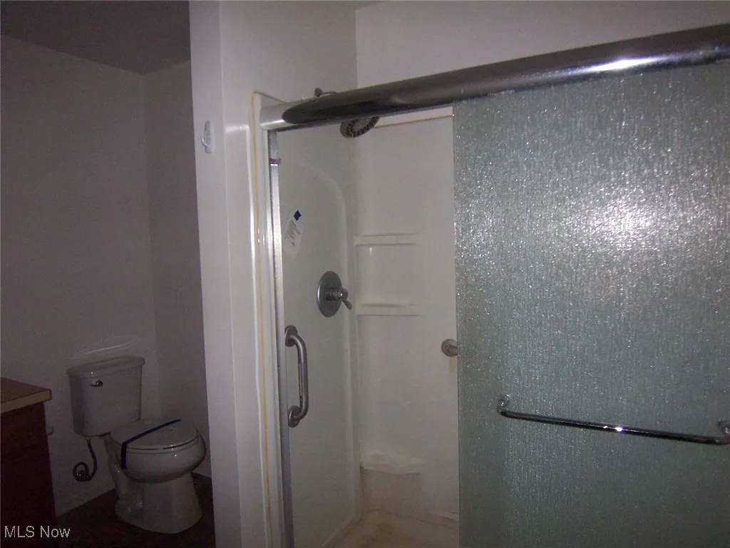 Bathroom featuring a shower stall and vanity