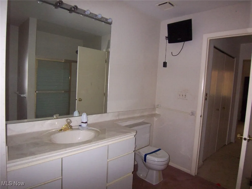 Bathroom with a stall shower and vanity