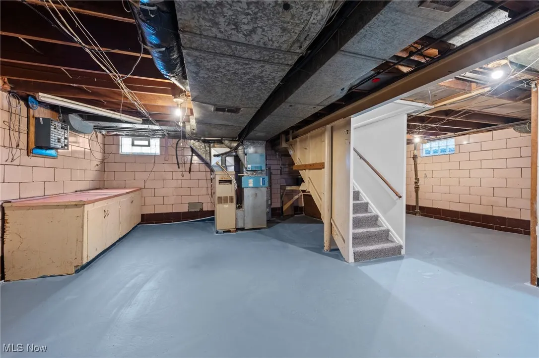 Basement with stairway and heating unit