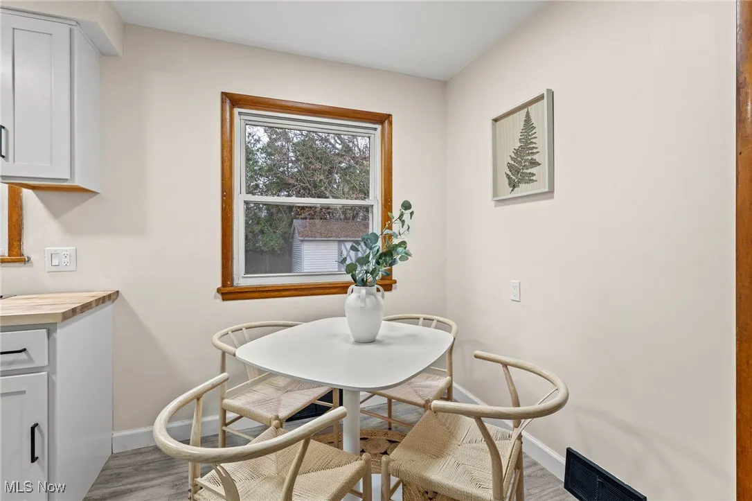 Dining space with baseboards and light wood-type flooring