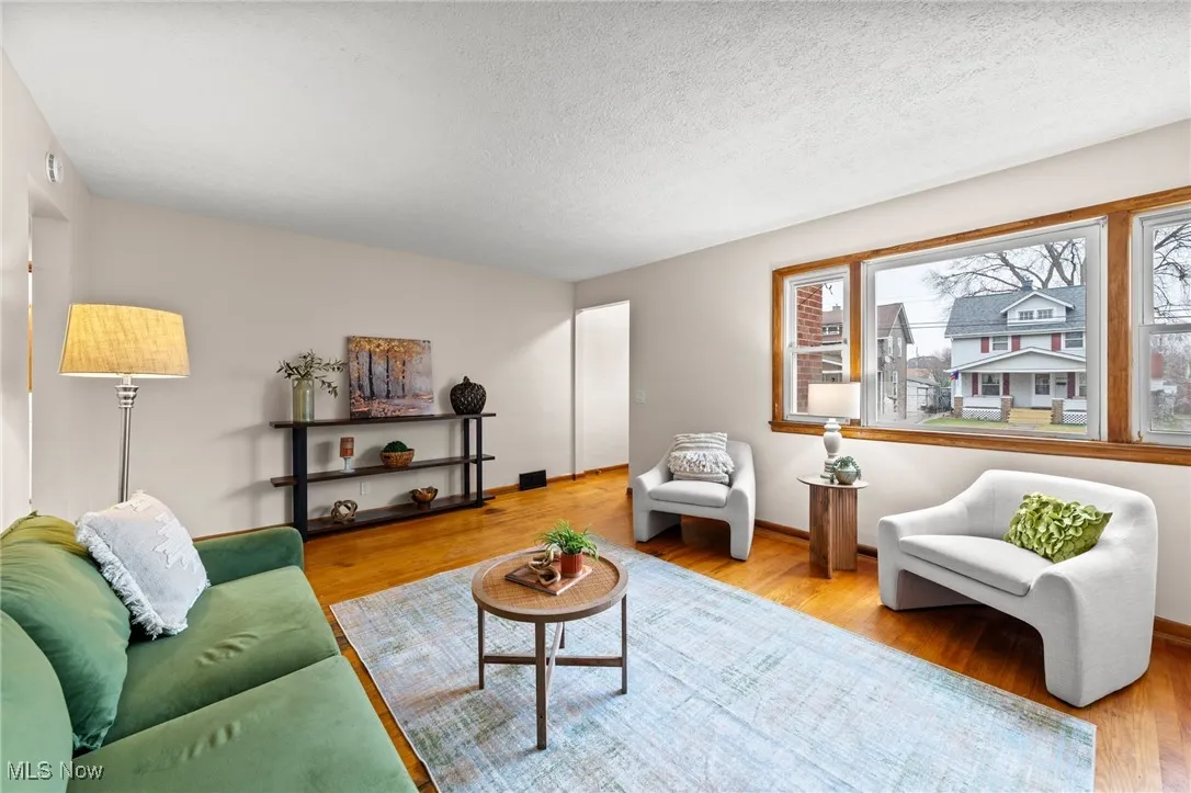 Living area with a textured ceiling and wood finished floors