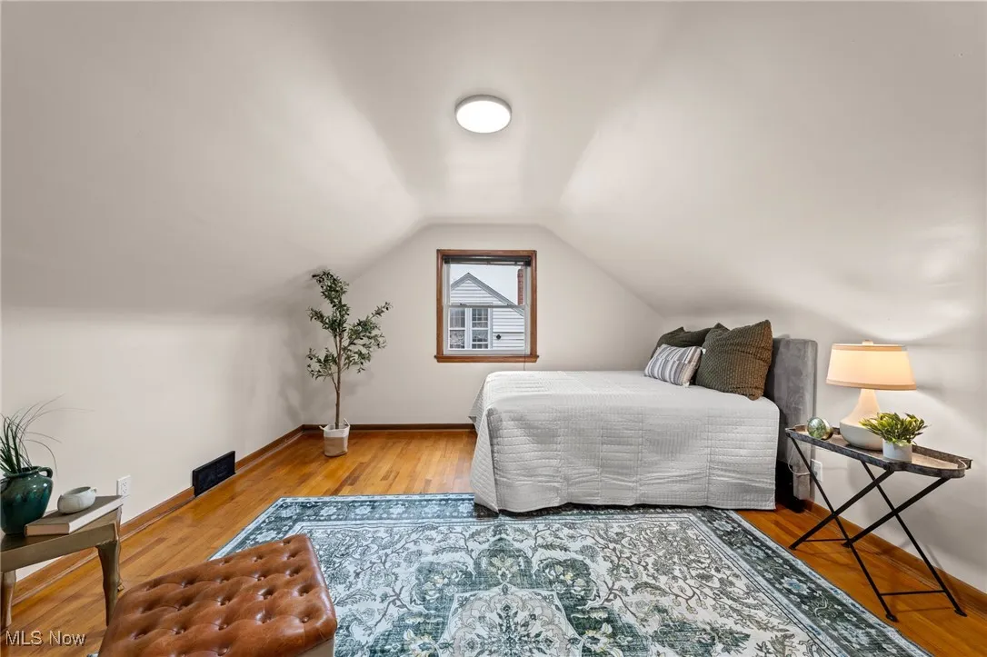 Bedroom featuring vaulted ceiling and wood finished floors