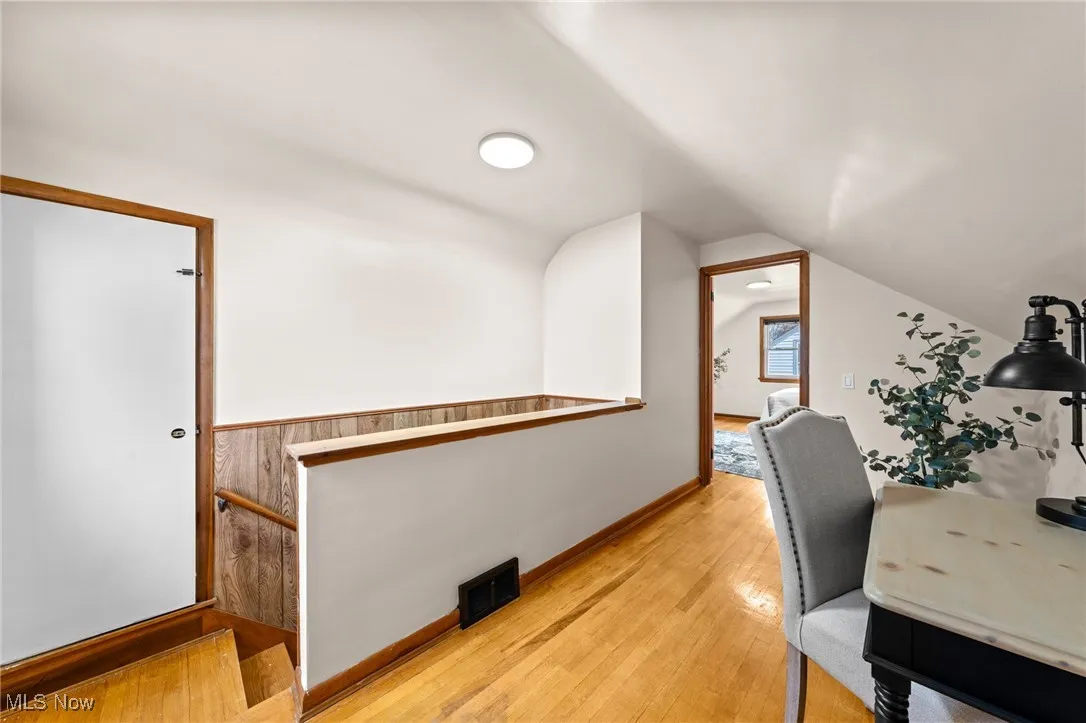 Office area featuring light wood finished floors and lofted ceiling