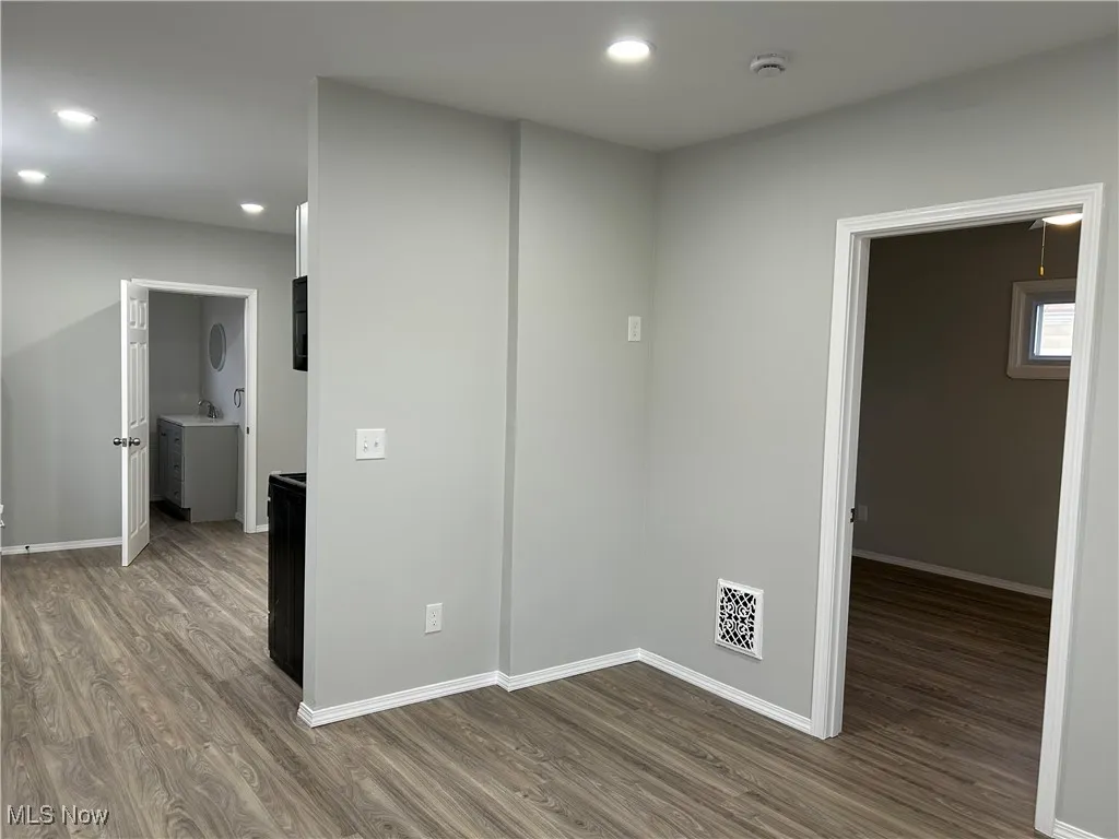 Spare room featuring dark wood-style floors and recessed lighting
