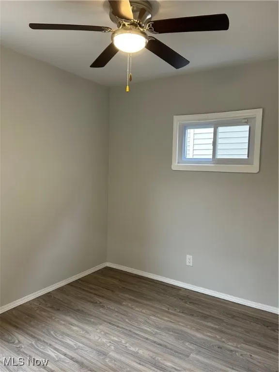 Bed room with wood finished floors and a ceiling fan