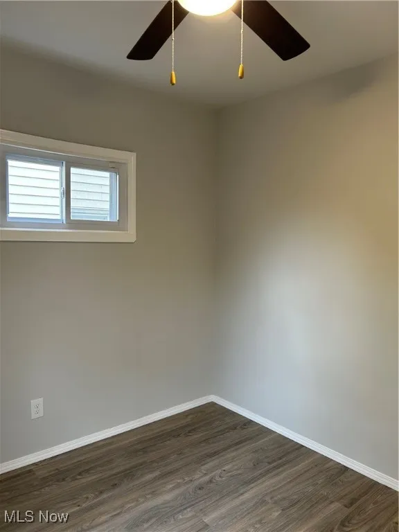 Bed room featuring dark wood-style flooring and ceiling fan