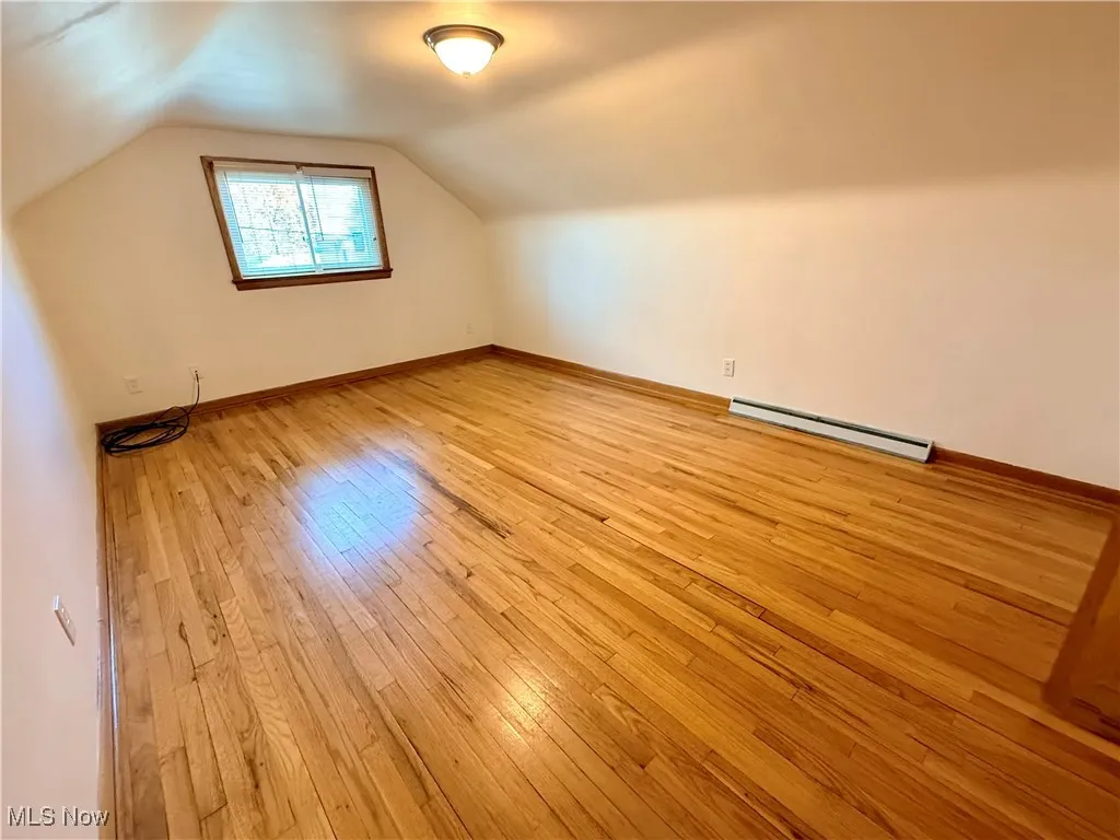 2nd bedroom with original wood floors, newer energy efficient window and fresh paint