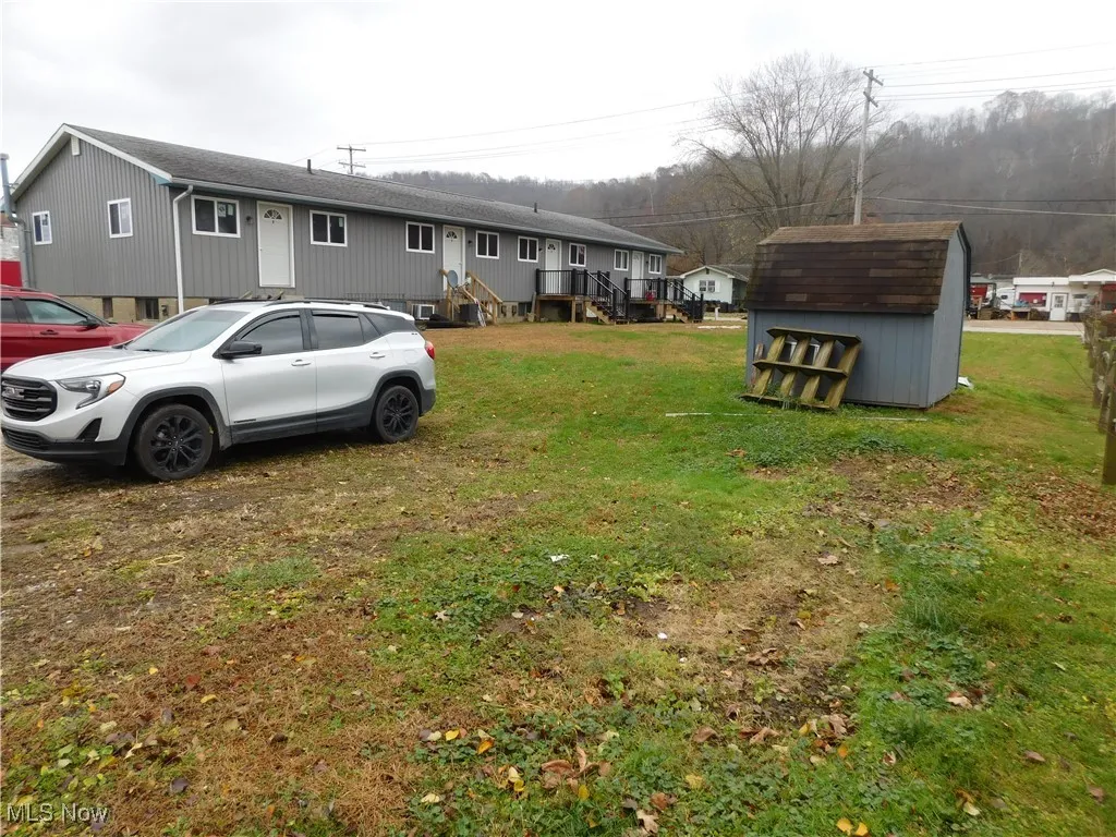 View of green lawn with a storage unit