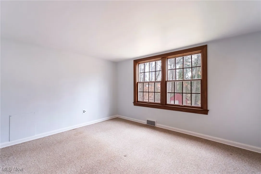 Unfurnished room featuring carpet and baseboards