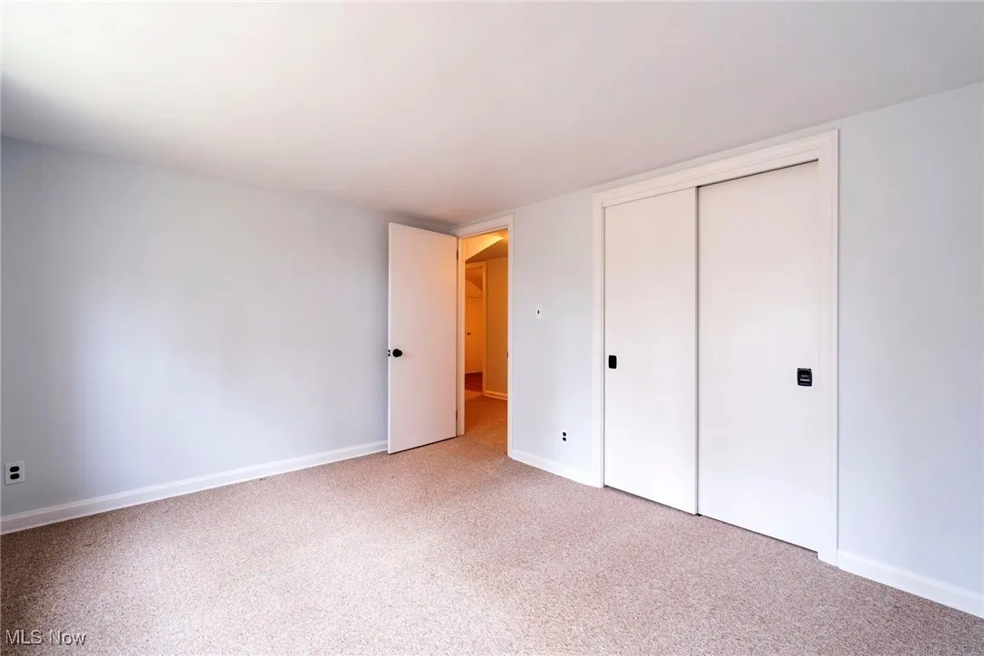 Unfurnished bedroom with a closet and carpet floors